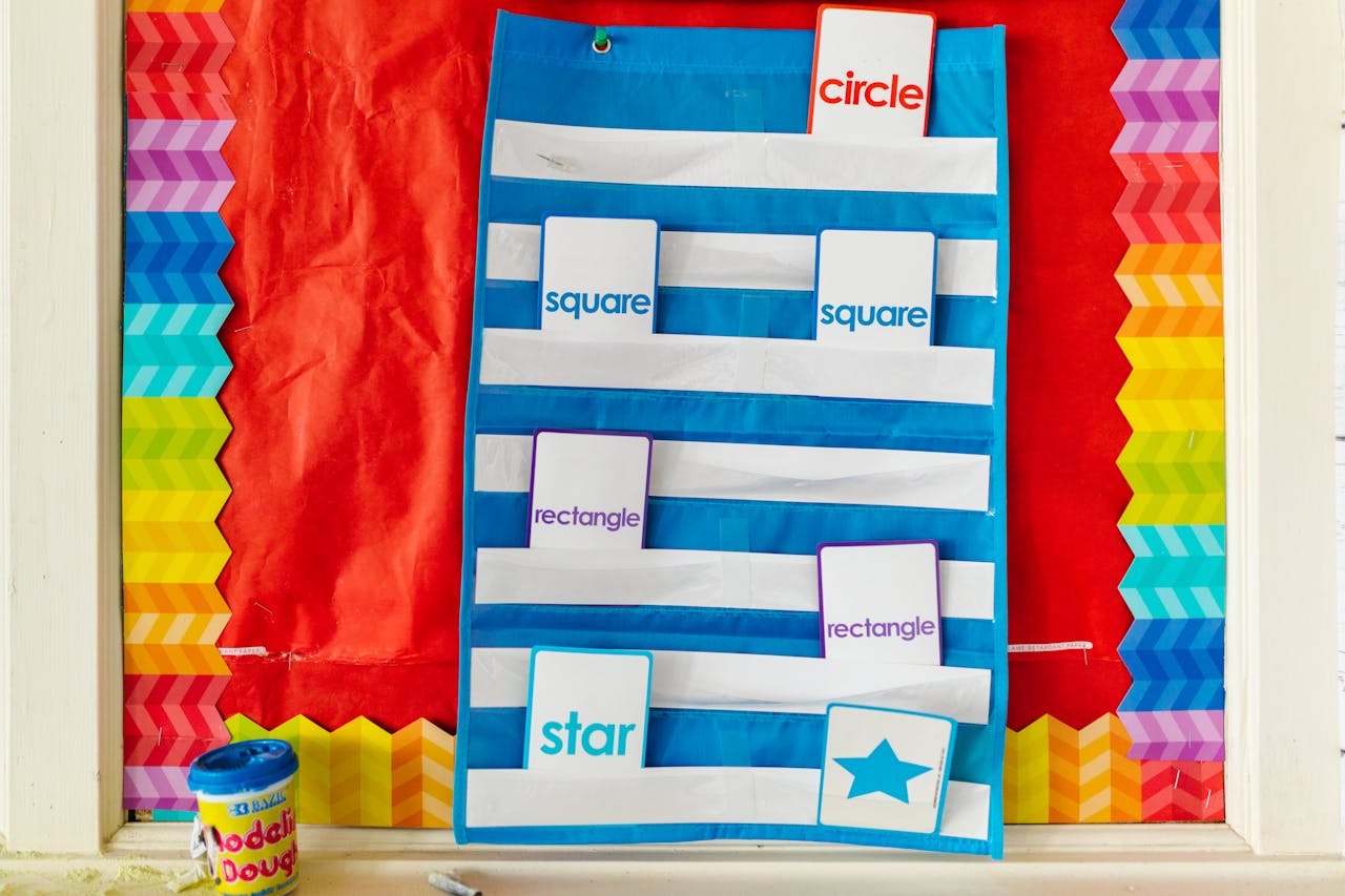 Bright classroom display featuring vibrant geometric shapes like circle, square, and star.